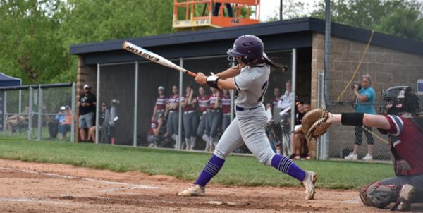 MGA Knights softball player hits a ball on the diamond during a game.